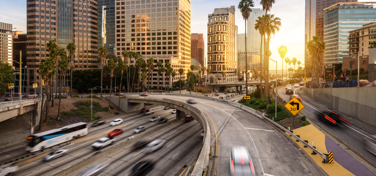 Left curving overpass in front of tall city buildings