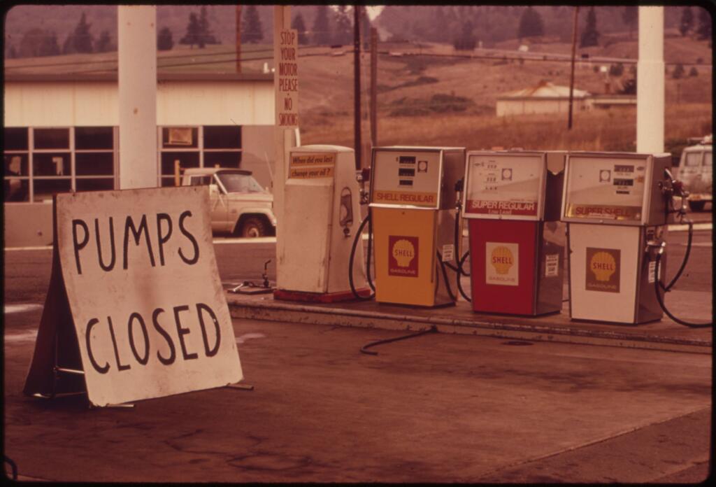 Gas pumps in Oregon with sign saying pumps are closed in 1973.