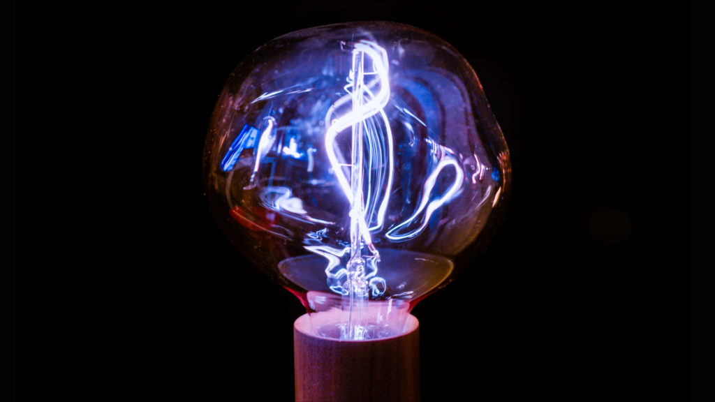 Light bulb with blue light against a black background